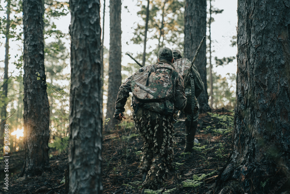 Turkey hunters sneaking through the forest. 